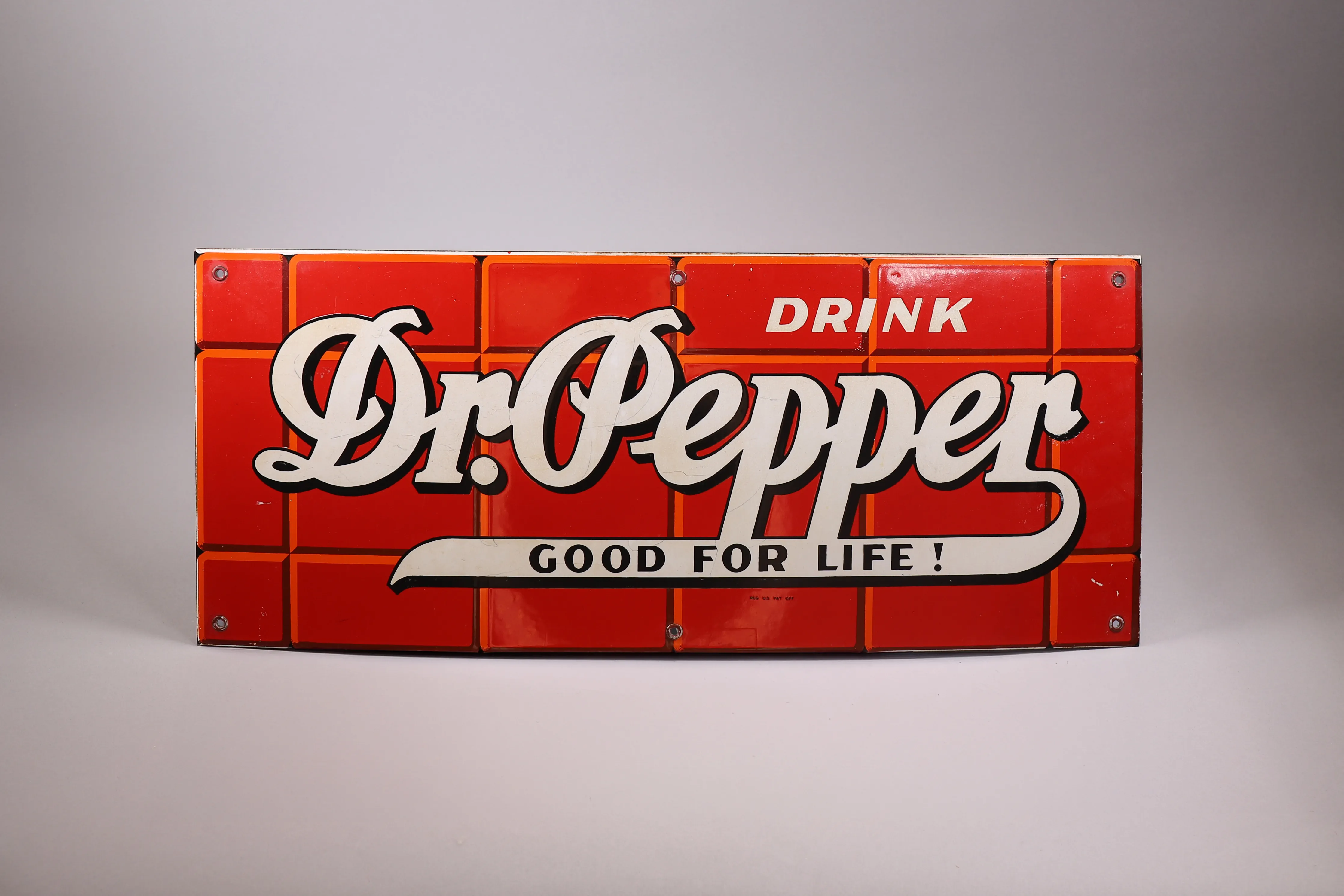 Vintage advertising sign photographed as a featured estate sale item.